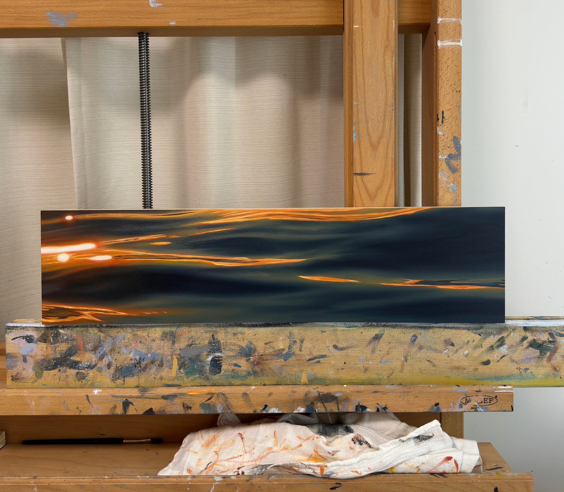 oil painting of the ocean water with orange sunrise reflection